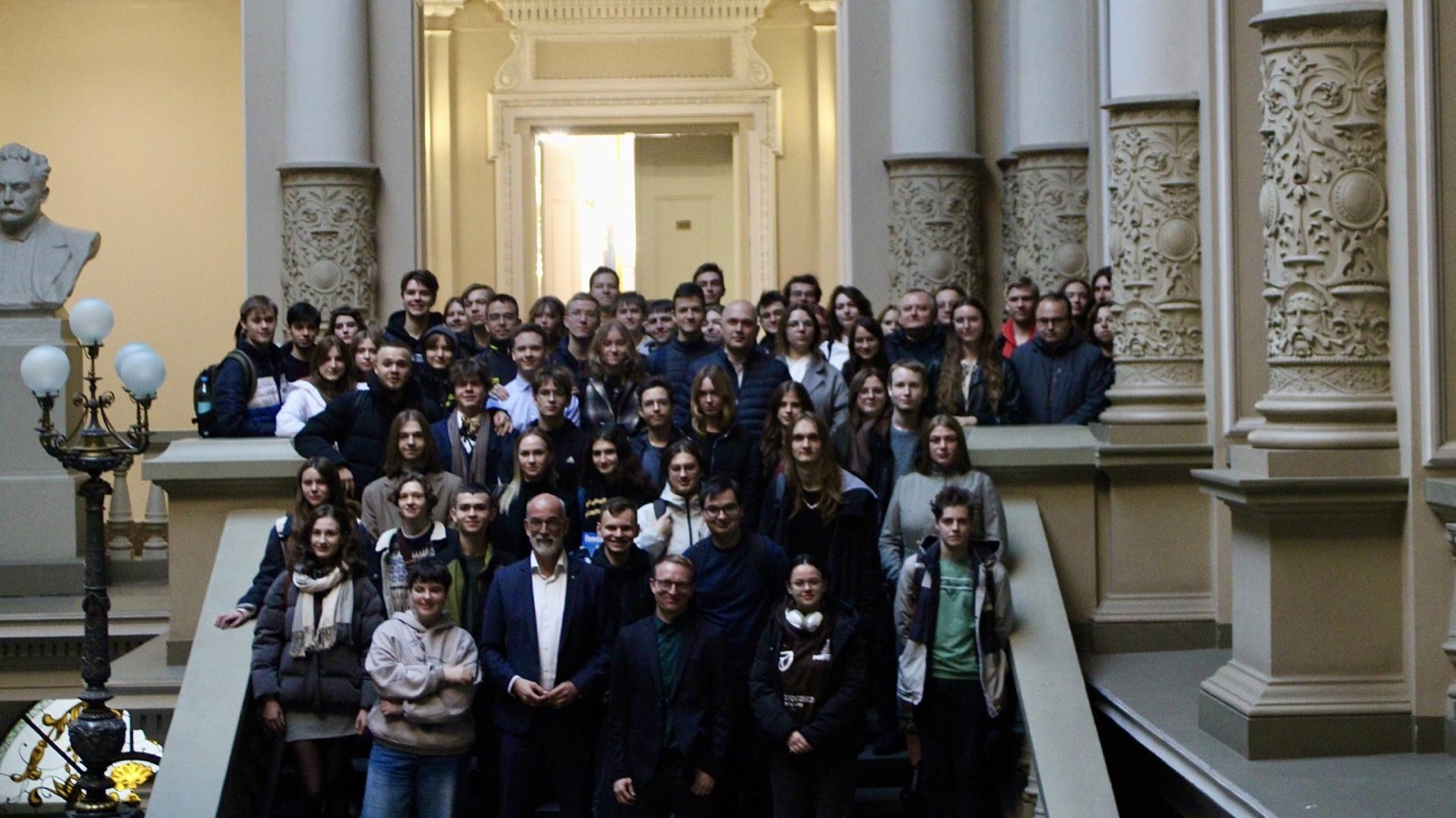 A large group of students gathered on the grand staircase of Ivan Franko National University of Lviv.