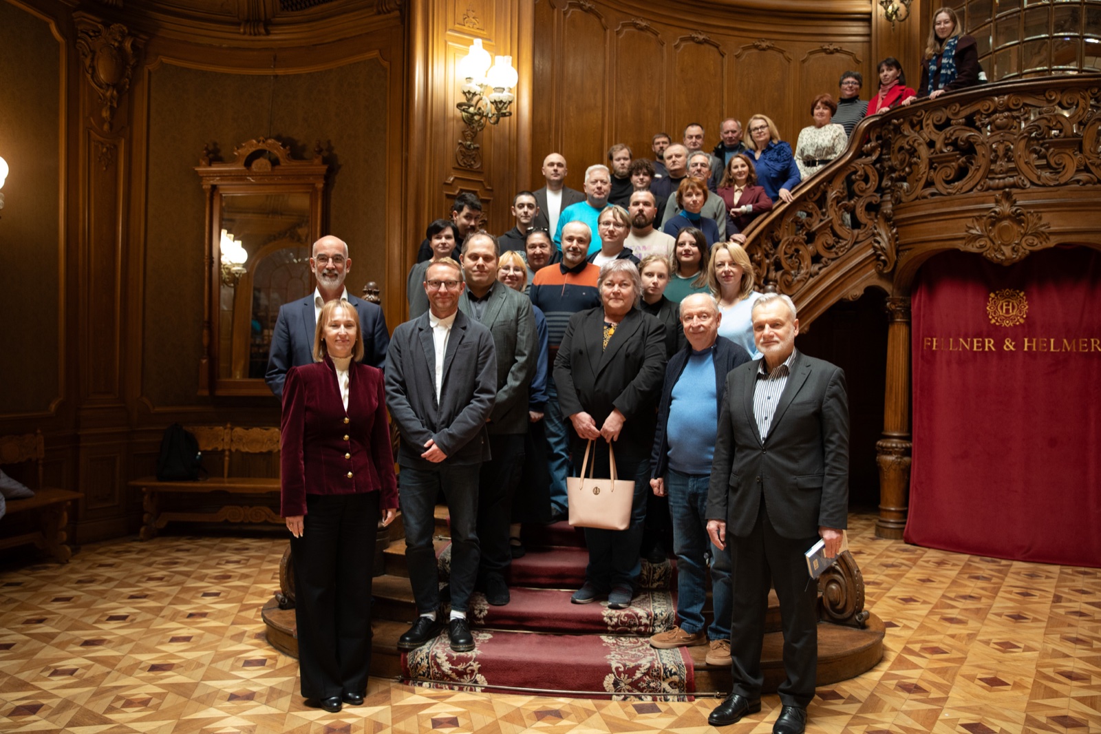 Participants of the teacher training and the letter of intent signing standing on the grand staircase of the House of Science in Lviv.